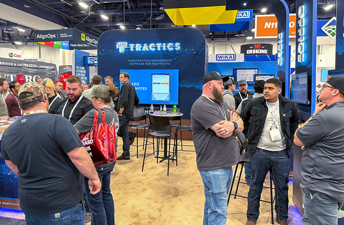 Tractics team demonstrating heavy civil construction management software to contractors at the CONEXPO trade show booth